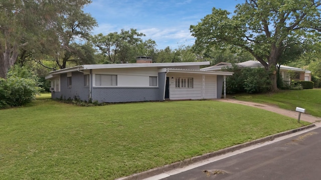 1429 W Water St, Weatherford, TX 76086 - view of front of house featuring a front lawn, brick siding, and a chimney