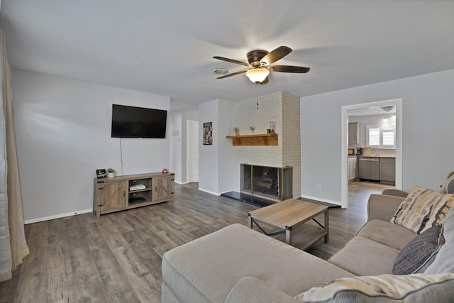 1429 W Water St, Weatherford, TX 76086 - living room featuring a ceiling fan, wood finished floors, a brick fireplace, and baseboards