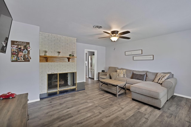 1429 W Water St, Weatherford, TX 76086 - living room featuring a ceiling fan, wood finished floors, baseboards, and a brick fireplace