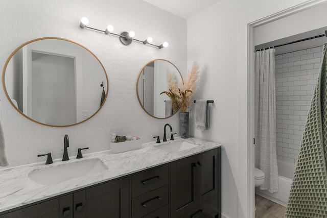 4005 Province Dr, Carrollton, TX 75007 - full bath with double vanity, toilet, shower / tub combo with curtain, and wood finished floors