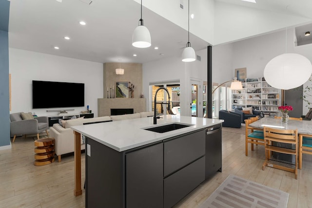 4005 Province Dr, Carrollton, TX 75007 - kitchen with open floor plan, a sink, light wood finished floors, an island with sink, and a high ceiling