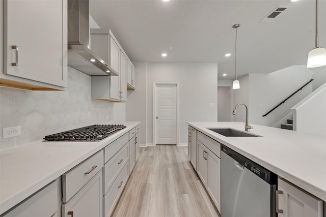 3404 Riverlawn Dr, Anna, TX 75409 - kitchen featuring appliances with stainless steel finishes, a sink, wall chimney range hood, decorative backsplash, and light wood-type flooring