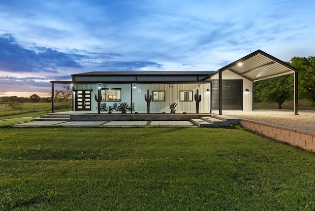 1210 Berger Rd, Temple, TX 76501 - back of property at dusk featuring a lawn, an attached garage, and a carport