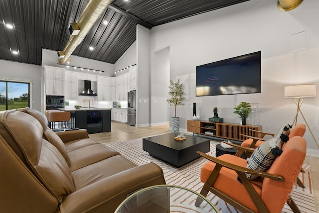 1210 Berger Rd, Temple, TX 76501 - living room featuring baseboards, light wood-style floors, high vaulted ceiling, and beamed ceiling