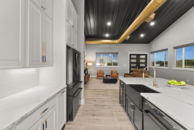1210 Berger Rd, Temple, TX 76501 - kitchen featuring high quality fridge, dishwashing machine, a sink, open floor plan, and white cabinets