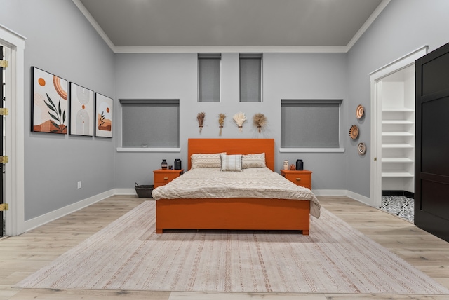 1210 Berger Rd, Temple, TX 76501 - bedroom with crown molding, light wood-type flooring, baseboards, and a spacious closet