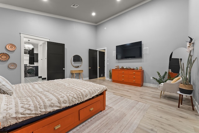 1210 Berger Rd, Temple, TX 76501 - bedroom with washer / clothes dryer, a high ceiling, light wood-type flooring, crown molding, and baseboards