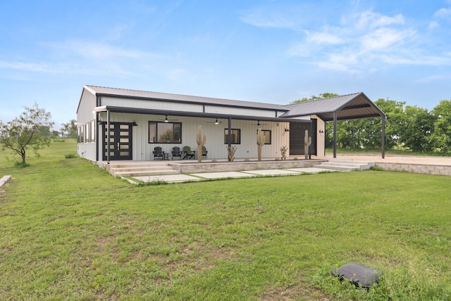1210 Berger Rd, Temple, TX 76501 - rear view of property featuring a lawn, metal roof, and ceiling fan