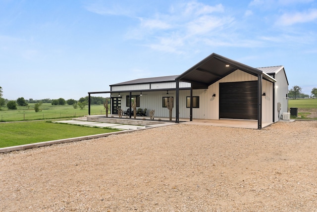 1210 Berger Rd, Temple, TX 76501 - view of front of home with ceiling fan, dirt driveway, a front lawn, central AC unit, and a patio area