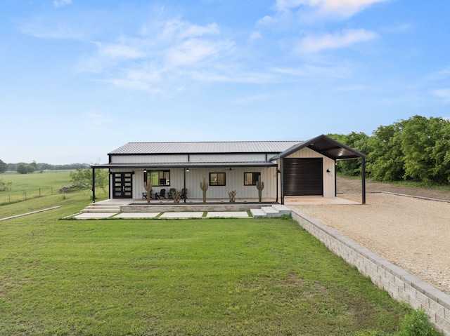1210 Berger Rd, Temple, TX 76501 - rear view of property with a lawn, dirt driveway, metal roof, covered porch, and board and batten siding