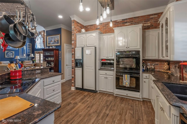 1171 Wemple Rd, Bossier City, LA 71111 - kitchen with black appliances, ornamental molding, glass insert cabinets, white cabinetry, and decorative light fixtures