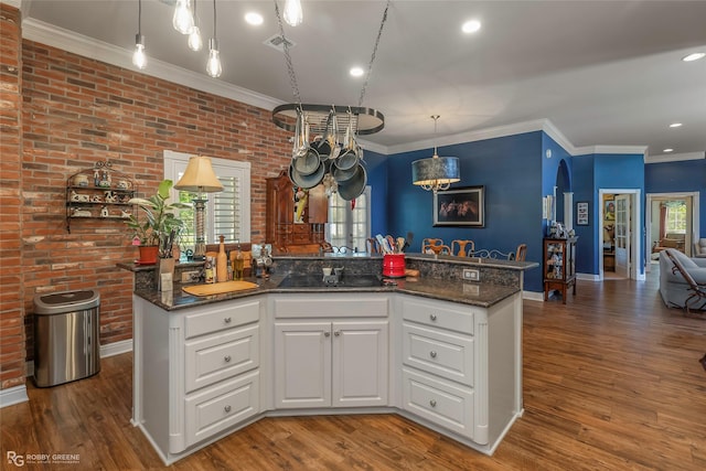 1171 Wemple Rd, Bossier City, LA 71111 - kitchen with ornamental molding, white cabinetry, dark stone counters, hanging light fixtures, and wood finished floors