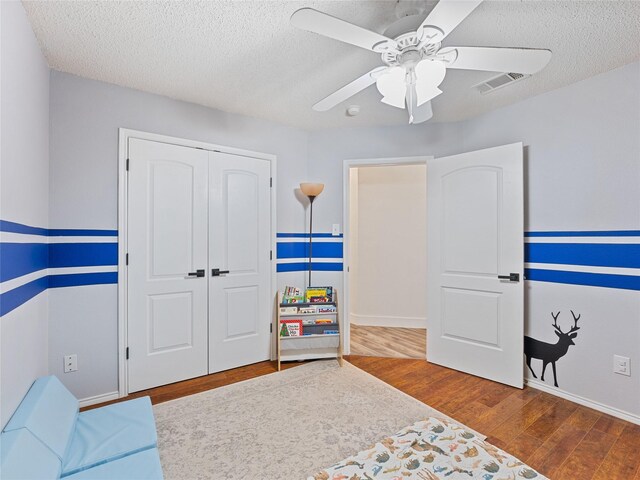 12200 Rolling Ridge Dr, Fort Worth, TX 76028 - sitting room featuring wood finished floors, a ceiling fan, a textured ceiling, and baseboards