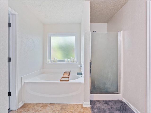 12200 Rolling Ridge Dr, Fort Worth, TX 76028 - bathroom with a shower stall, a bath, and a textured ceiling