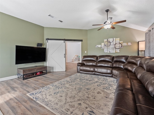 12200 Rolling Ridge Dr, Fort Worth, TX 76028 - living room featuring a barn door, wood finished floors, ceiling fan, lofted ceiling, and baseboards