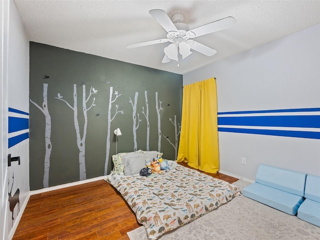 12200 Rolling Ridge Dr, Fort Worth, TX 76028 - bedroom with a textured ceiling, wood finished floors, ceiling fan, and baseboards