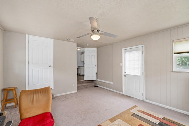 1701 Lawther Dr, River Oaks, TX 76114 - unfurnished room featuring plenty of natural light, baseboards, a ceiling fan, a textured ceiling, and carpet floors