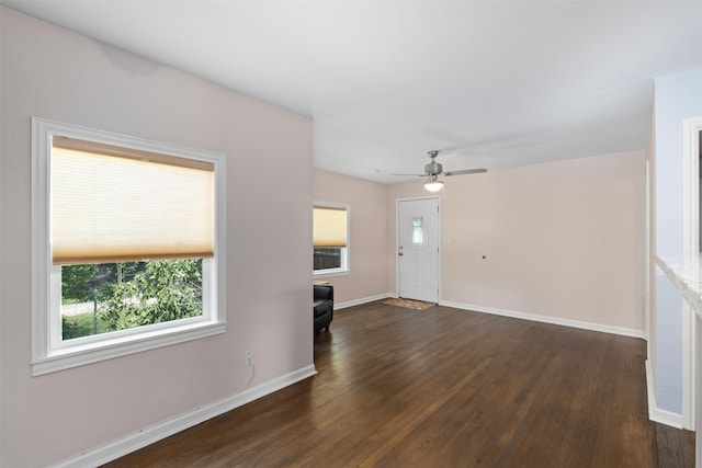 1701 Lawther Dr, River Oaks, TX 76114 - unfurnished living room with plenty of natural light, dark wood-type flooring, baseboards, and a ceiling fan