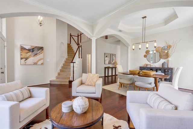 8508 Halkin Ct, Plano, TX 75024 - living room with arched walkways, crown molding, stairway, wood finished floors, and decorative columns