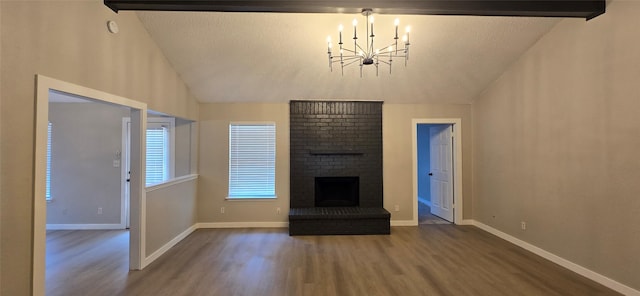 6648 Inwood Dr, Watauga, TX 76148 - unfurnished living room with wood finished floors, a chandelier, vaulted ceiling, a brick fireplace, and baseboards