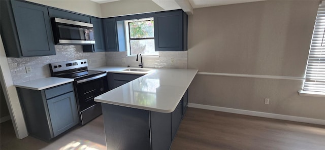 6648 Inwood Dr, Watauga, TX 76148 - kitchen with appliances with stainless steel finishes, a peninsula, light wood finished floors, and healthy amount of natural light