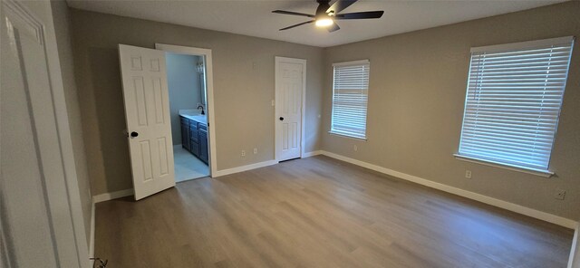 6648 Inwood Dr, Watauga, TX 76148 - unfurnished bedroom with wood finished floors, baseboards, ensuite bath, and ceiling fan
