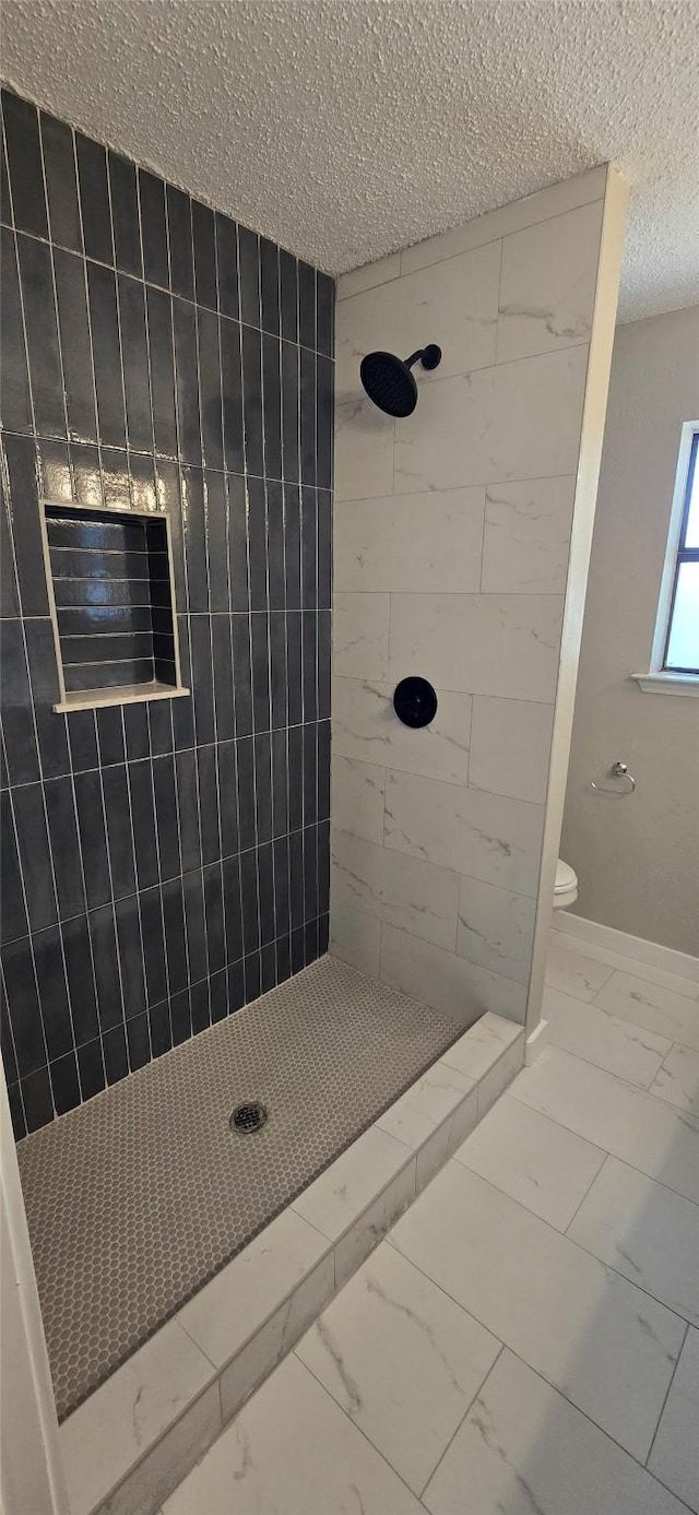 6648 Inwood Dr, Watauga, TX 76148 - bathroom with marble look tiles, a textured ceiling, tiled shower, and toilet
