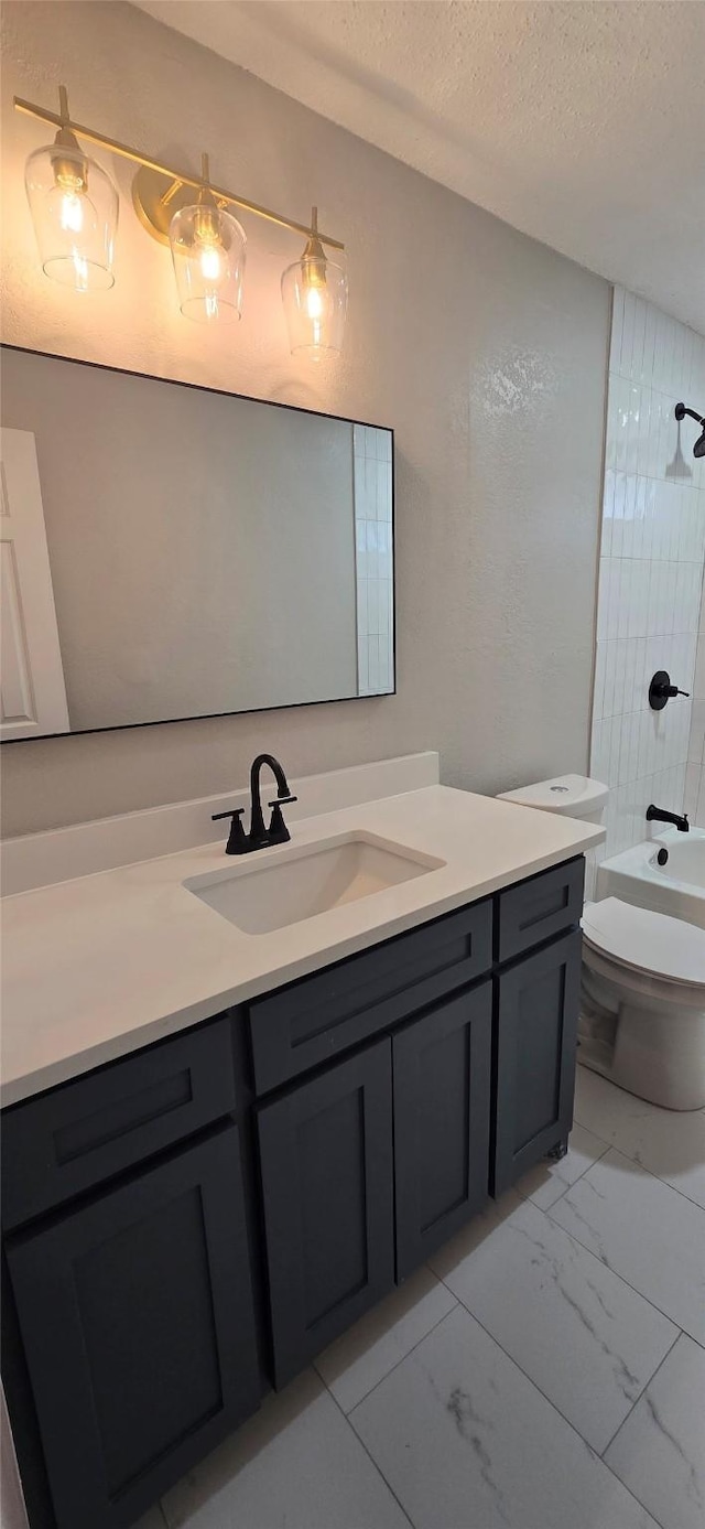 6648 Inwood Dr, Watauga, TX 76148 - bathroom featuring vanity, marble look tiles, toilet, shower / washtub combination, and a textured ceiling