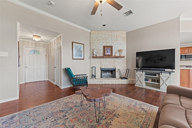 10161 Aragon Dr, Waco, TX 76708 - living room with wood finished floors, crown molding, a ceiling fan, a stone fireplace, and baseboards