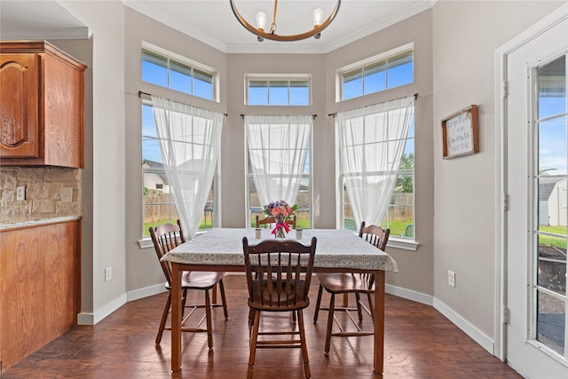 10161 Aragon Dr, Waco, TX 76708 - dining area featuring a chandelier, crown molding, plenty of natural light, dark wood-style floors, and baseboards