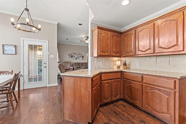 10161 Aragon Dr, Waco, TX 76708 - kitchen featuring a chandelier, decorative backsplash, light stone countertops, crown molding, and recessed lighting