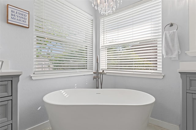 10161 Aragon Dr, Waco, TX 76708 - bathroom featuring vanity, baseboards, and a freestanding bath