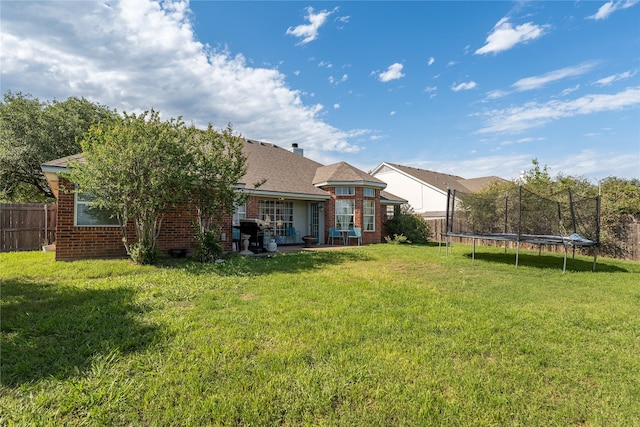 10161 Aragon Dr, Waco, TX 76708 - rear view of property with a trampoline, brick siding, and a patio area