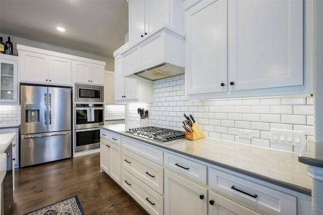 3812 Ironbark Way, Mckinney, TX 75071 - kitchen with appliances with stainless steel finishes, tasteful backsplash, white cabinetry, glass insert cabinets, and light countertops