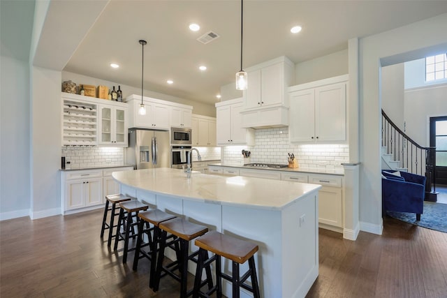 3812 Ironbark Way, Mckinney, TX 75071 - kitchen featuring appliances with stainless steel finishes, a sink, dark wood finished floors, a breakfast bar area, and recessed lighting