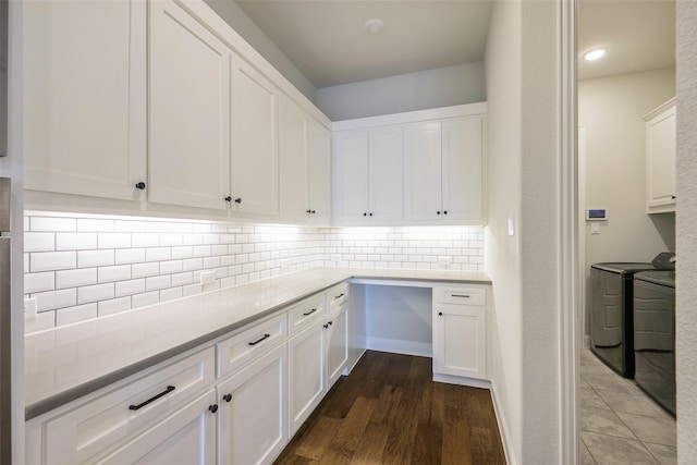 3812 Ironbark Way, Mckinney, TX 75071 - kitchen featuring washing machine and dryer, white cabinetry, decorative backsplash, light countertops, and dark wood-type flooring