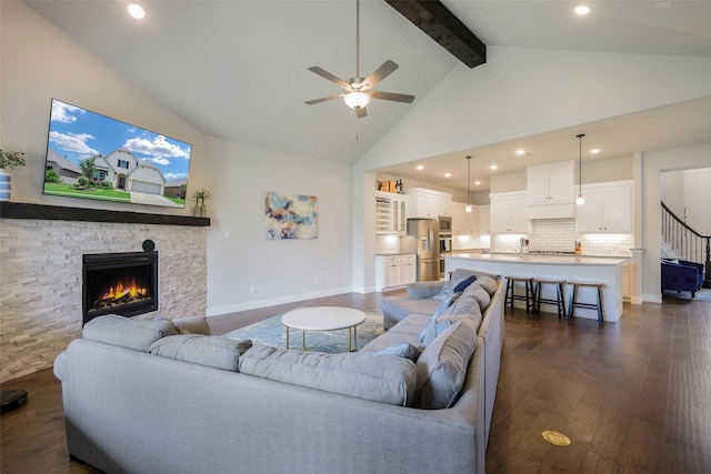 3812 Ironbark Way, Mckinney, TX 75071 - living room with ceiling fan, dark wood-type flooring, a stone fireplace, beamed ceiling, and high vaulted ceiling