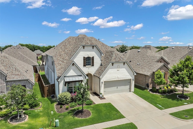 3812 Ironbark Way, Mckinney, TX 75071 - view of front of home with brick siding, driveway, an attached garage, and a front lawn