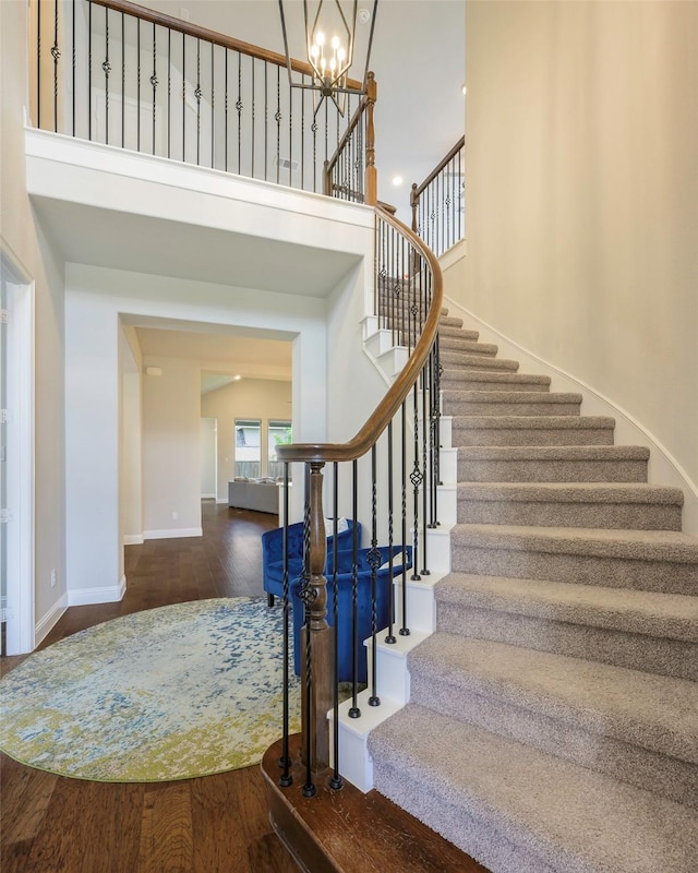 3812 Ironbark Way, Mckinney, TX 75071 - stairway with wood finished floors, a chandelier, baseboards, and a high ceiling