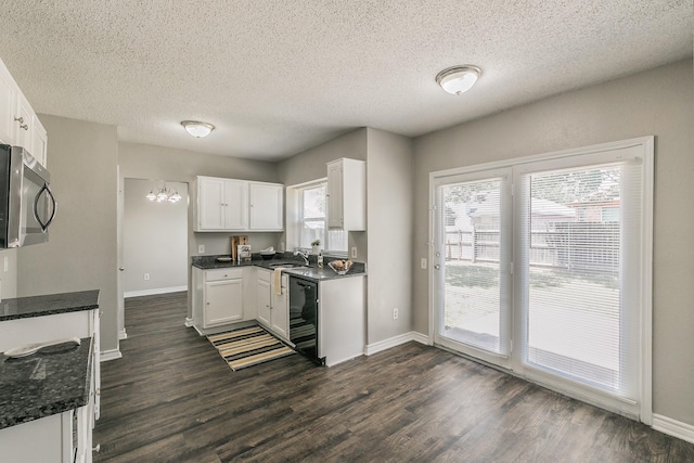 3733 River Birch Rd, Fort Worth, TX 76137 - kitchen featuring stainless steel microwave, dark wood finished floors, white cabinetry, baseboards, and a textured ceiling