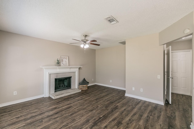 3733 River Birch Rd, Fort Worth, TX 76137 - unfurnished living room with ceiling fan, dark wood-style floors, a fireplace, a textured ceiling, and baseboards