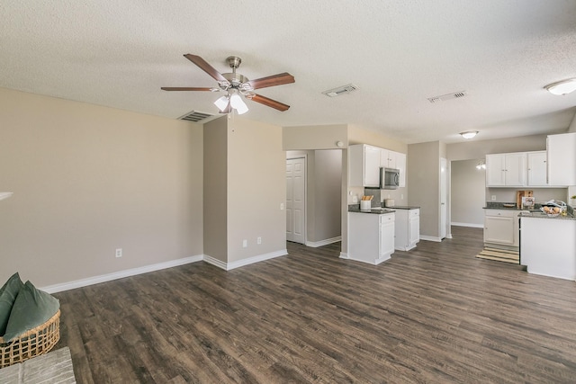 3733 River Birch Rd, Fort Worth, TX 76137 - unfurnished living room featuring a textured ceiling, dark wood-style flooring, baseboards, and ceiling fan