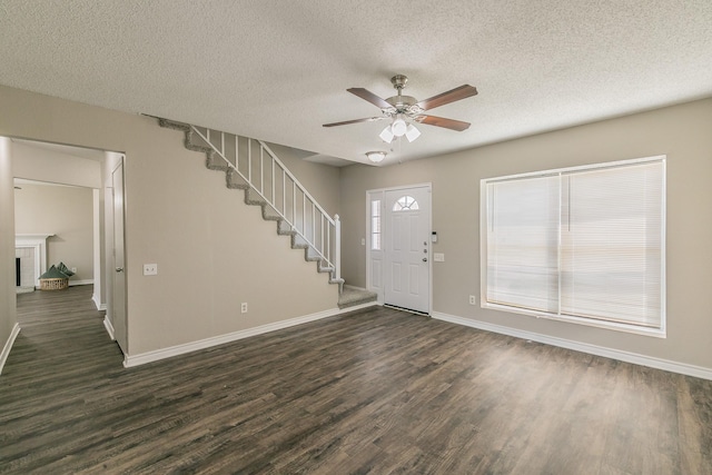 3733 River Birch Rd, Fort Worth, TX 76137 - foyer featuring dark wood-style flooring, a ceiling fan, baseboards, a textured ceiling, and stairs