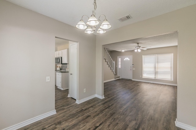 3733 River Birch Rd, Fort Worth, TX 76137 - empty room with dark wood-style flooring, a chandelier, baseboards, ceiling fan, and a textured ceiling