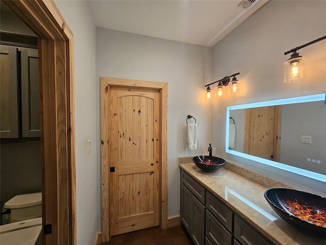 437 County Road 3190, Winnsboro, TX 75494 - bathroom with double vanity and toilet