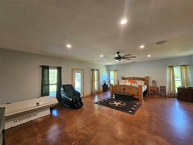 437 County Road 3190, Winnsboro, TX 75494 - bedroom with concrete floors, recessed lighting, multiple windows, a textured ceiling, and access to outside