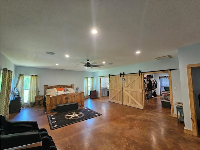 437 County Road 3190, Winnsboro, TX 75494 - bedroom with a barn door, recessed lighting, and finished concrete floors