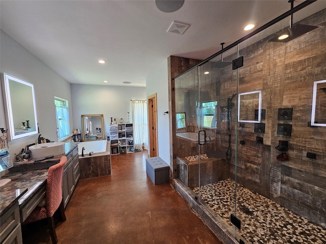 437 County Road 3190, Winnsboro, TX 75494 - bathroom with finished concrete flooring, a shower stall, vanity, a bath, and recessed lighting