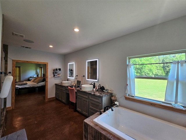 437 County Road 3190, Winnsboro, TX 75494 - ensuite bathroom featuring double vanity, a bath, recessed lighting, baseboards, and concrete flooring