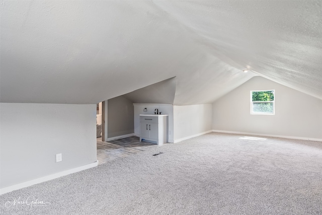 2383 Julia St, Bossier City, LA 71112 - bonus room with a textured ceiling, carpet, baseboards, and vaulted ceiling